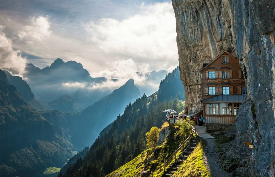 a house in a gap between the rocky Mountains